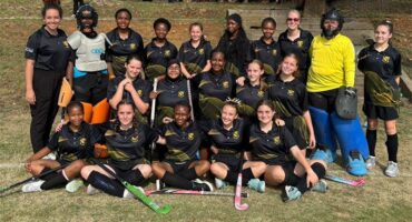 a hockey team in black sport kit