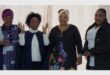 Four women standing next to each other