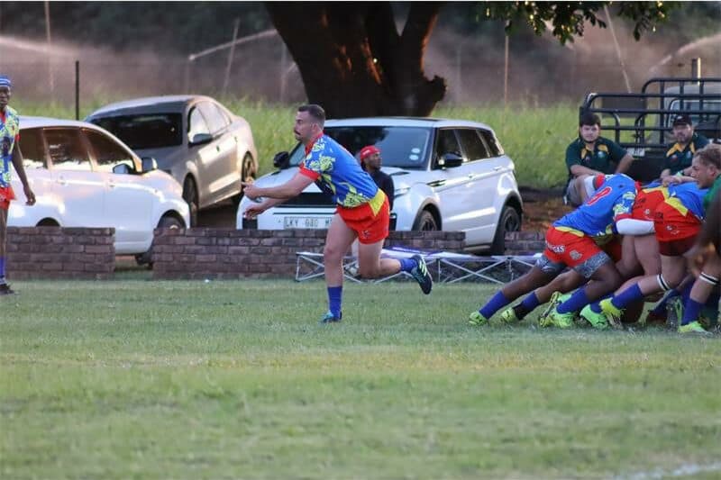 A rugby player passes out the ball
