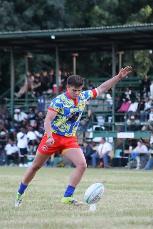 A ruby player prepares to kick the ball