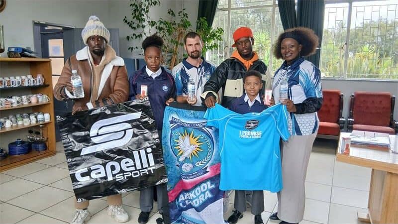 Wesley Ntshangase, founder of the I Promise Football School, with Karabo Masenye of Laerskool Leandra’s girls soccer team,