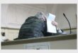 a man in the court dock covers his face