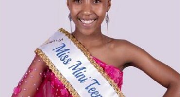 girl with a crown and a beauty pageant sash