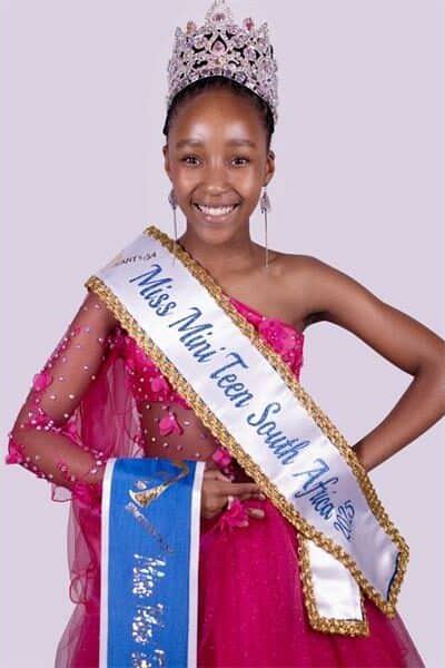girl with a crown and a beauty pageant sash