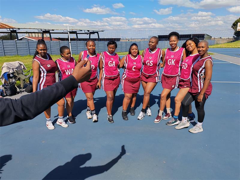 a netball team with maroon kits