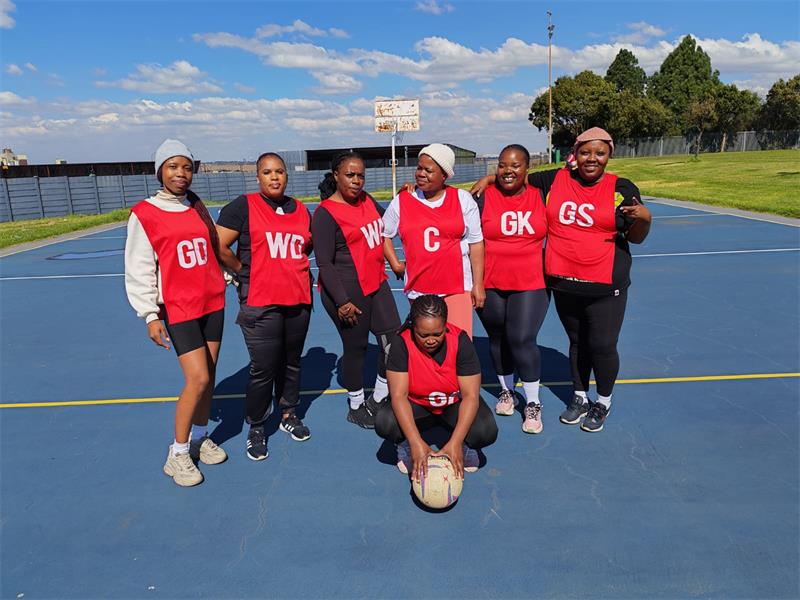 a netball team with red bibs