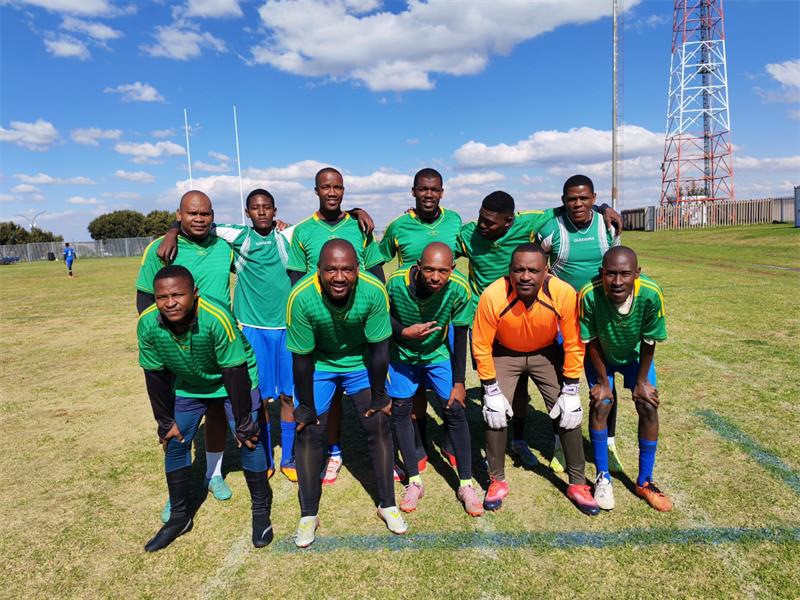 a soccer team with green and blue kits