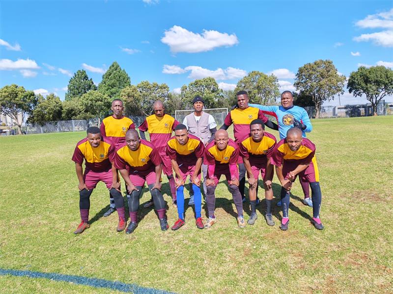 a soccer team with maroon and yellow kits