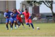 soccer teams in red and blue vie for the ball