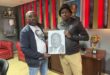 two men with a portrait sketch