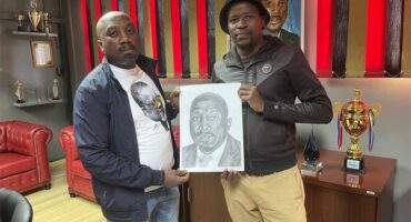 two men with a portrait sketch