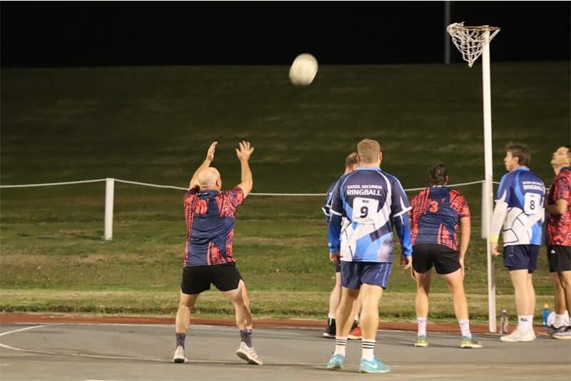 a player with the ball aims for the goal post