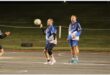 a player with the ball aims for the goal post