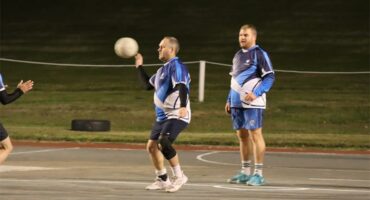 a player with the ball aims for the goal post