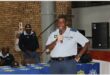 man in police uniform speaks into a microphone