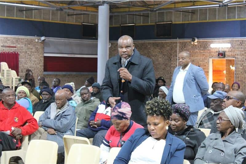 a man i the audience stands up and speaks into a microphone