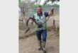 man holding snake with the necessary care