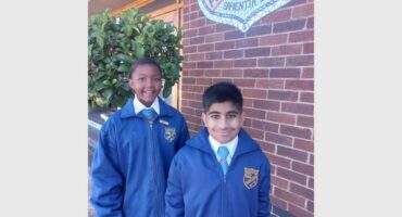 Two boys in blue school uniforms