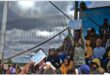 people hold up posters on a pavilion