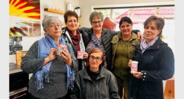 a group of women with mugs