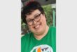 a smiling with in a green VF t-shirt