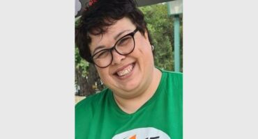 a smiling with in a green VF t-shirt