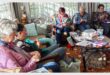 a group of women crocheting in a a lounge