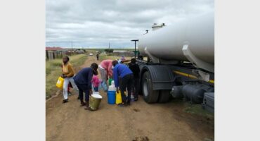 people getting water from a water tanker