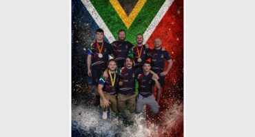 group of men in front of the South African flag