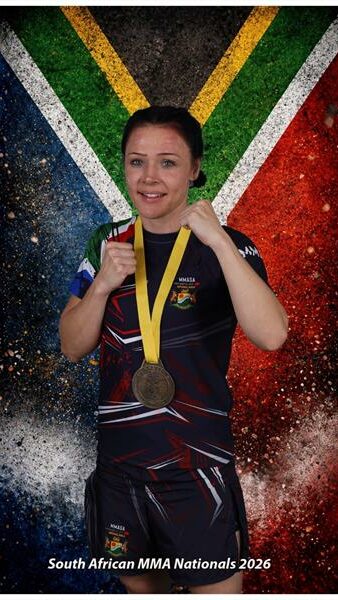 woman with a medal in front of SA flag