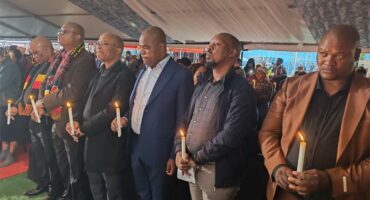 men holding up candles