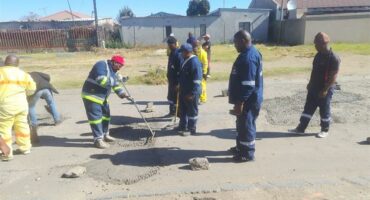 Members of Vukanini Taxi Association patch potholes in eMbalenhle.