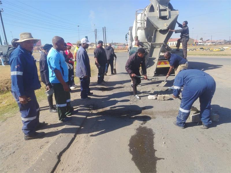 Members of Vukanini Taxi Association patch potholes in eMbalenhle.