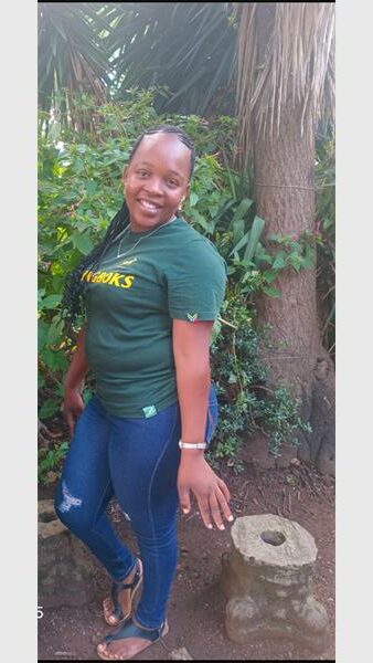 The woman with a green shirt and denim