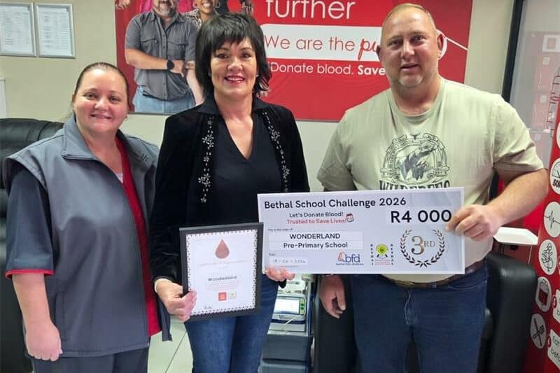 Three people with a certificate and a large checque