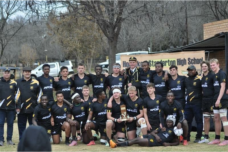 a team of rugby players in white and black