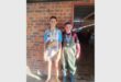 two young boys with medals around their necks