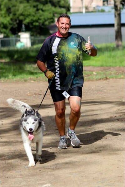 a man running with her dog