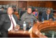people sitting in a council chamber