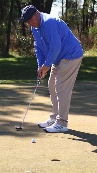 golf player in a light blue jacket