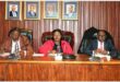 Two men and a woman sitting at the council mayoral bench
