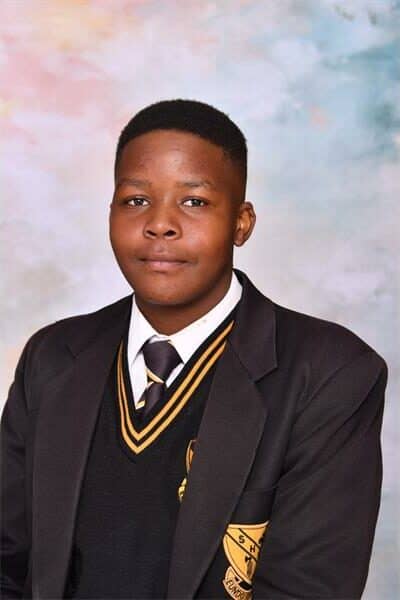 Boy in black and yellow school uniform