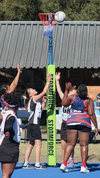 netball teams from two schools compete for the ball
