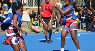 netball teams from two schools compete for the ball