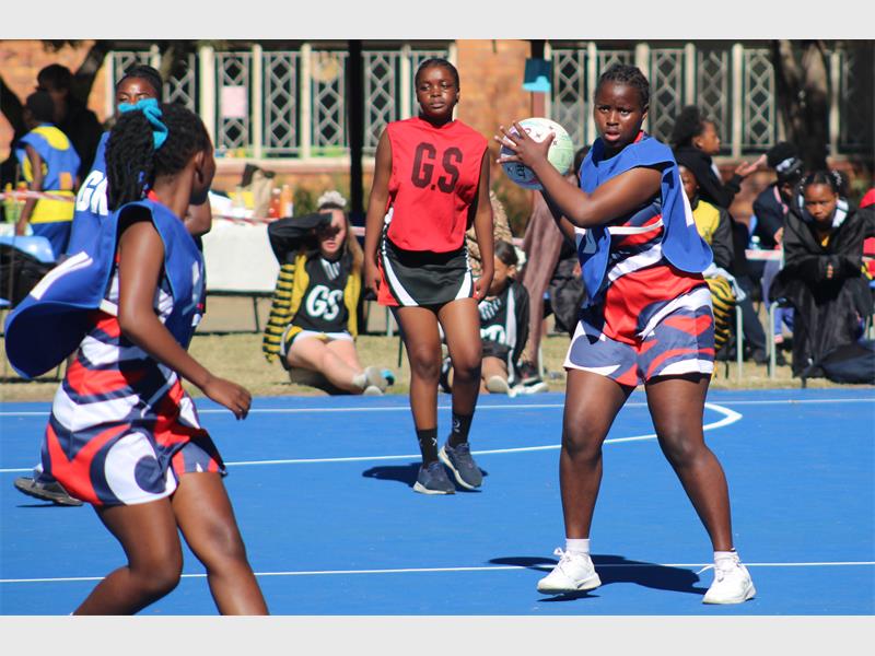 netball teams from two schools compete for the ball