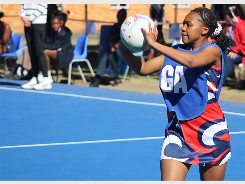 netball teams from two schools compete for the ball