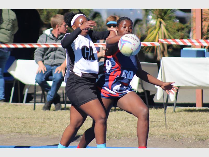 netball teams from two schools compete for the ball