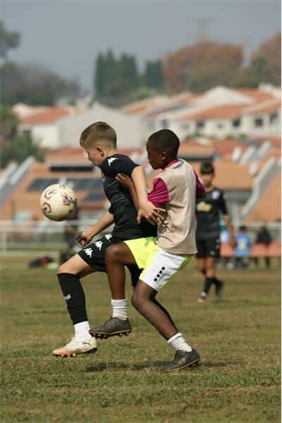 two teams battle for the soccer ball
