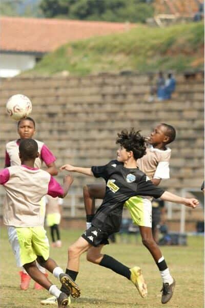 two teams battle for the soccer ball