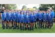 a large group of boys in blue school uniforms